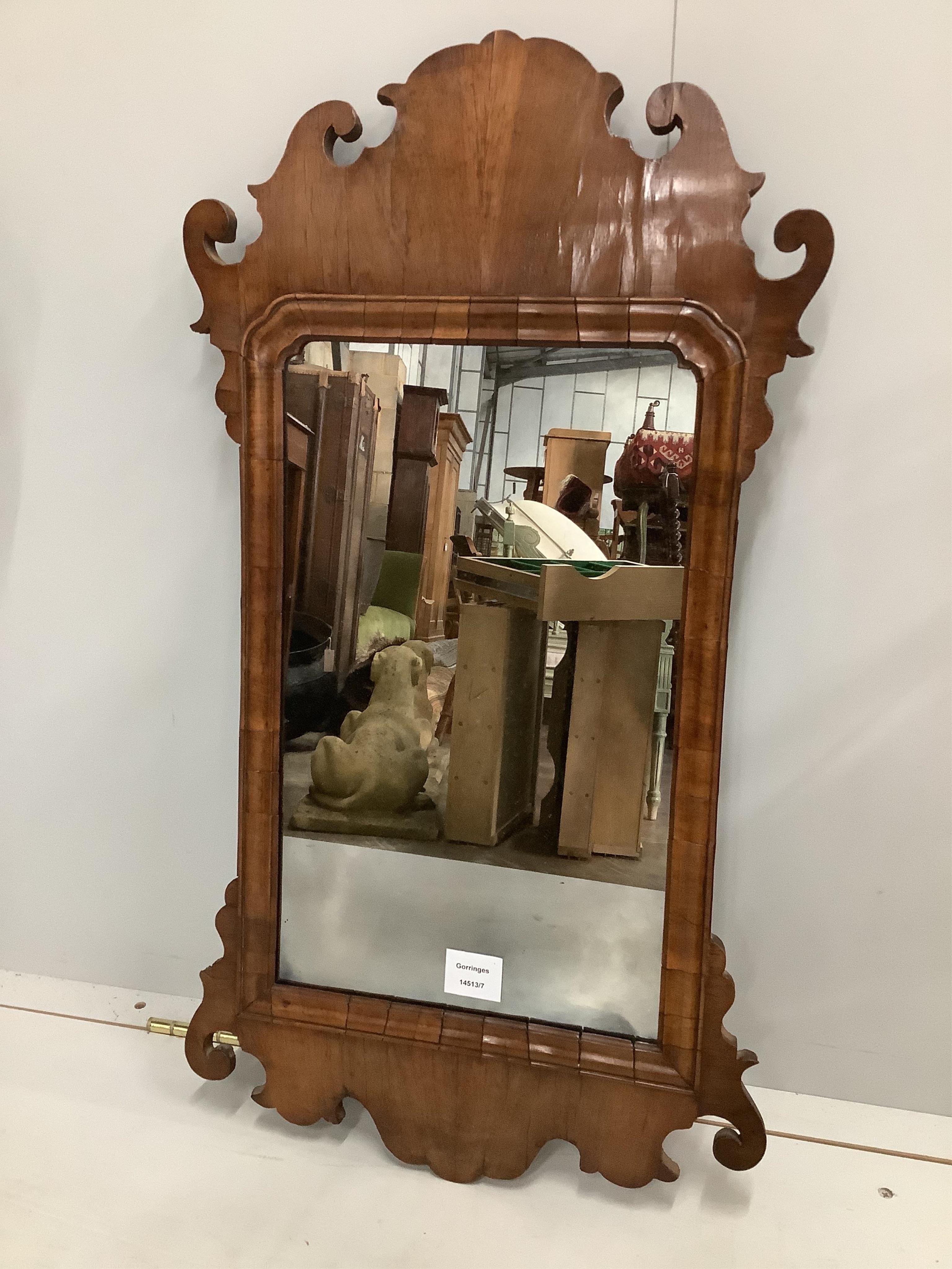 A walnut fret cut wall mirror, width 41cm, height 75cm. Condition - good